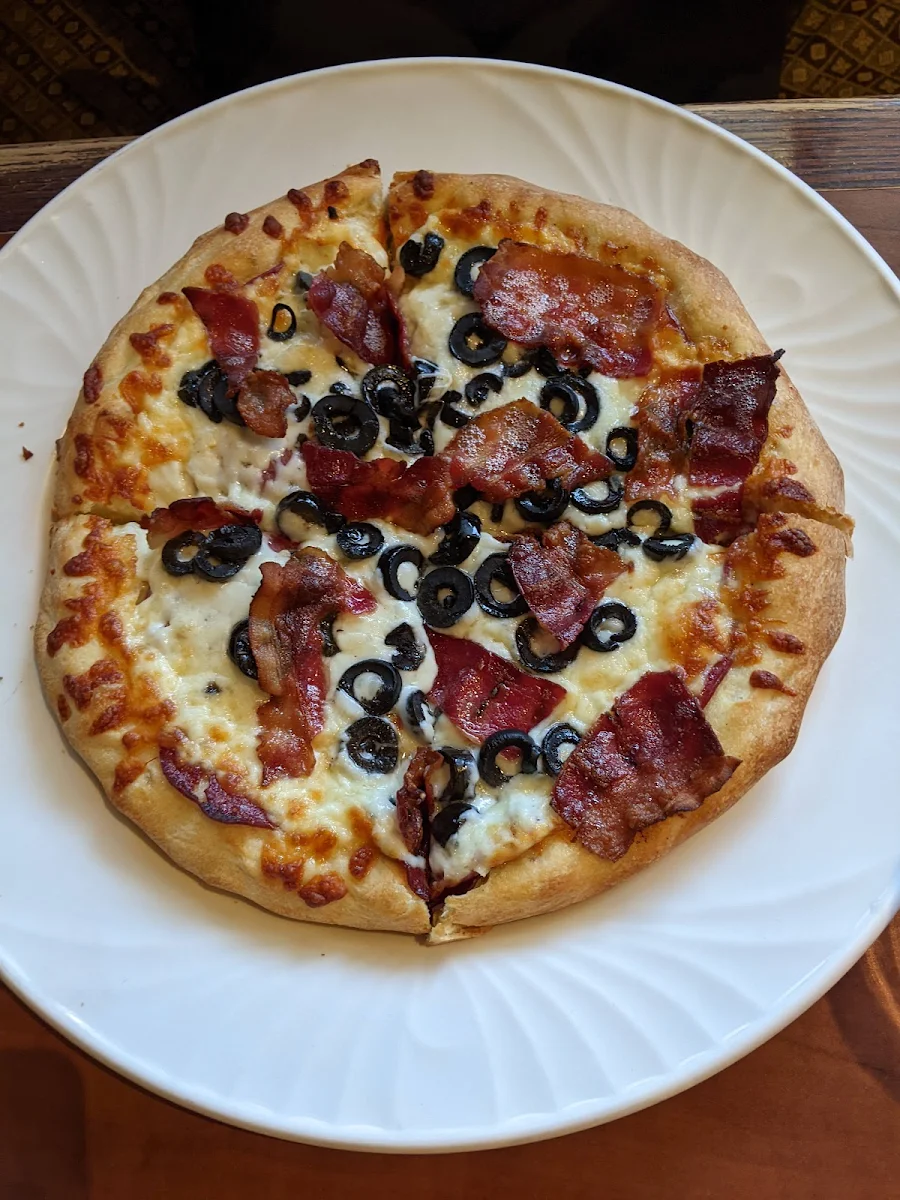 Pizza with Pepperoni Bacon and Black Olives