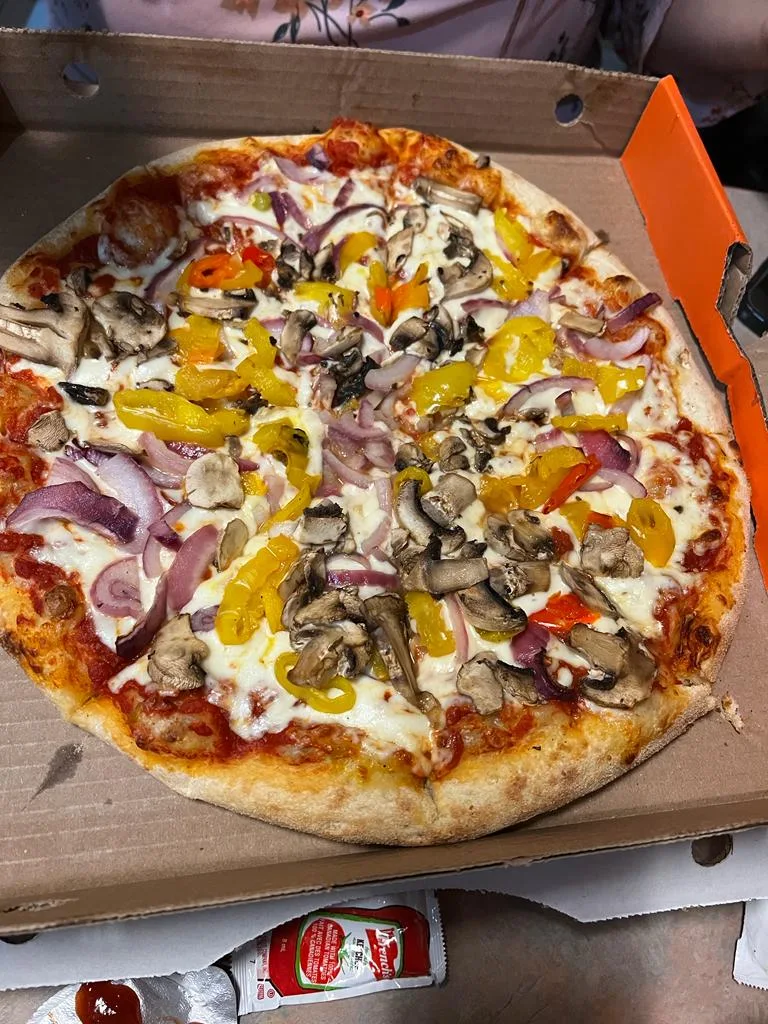 Medium Pizza with Regular Base and Toppings Were Red Pepper Mushrooms and Onion