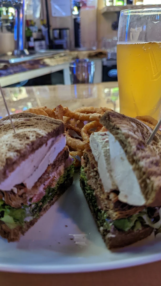 A Turkey Club Sandwich and Onion Rings