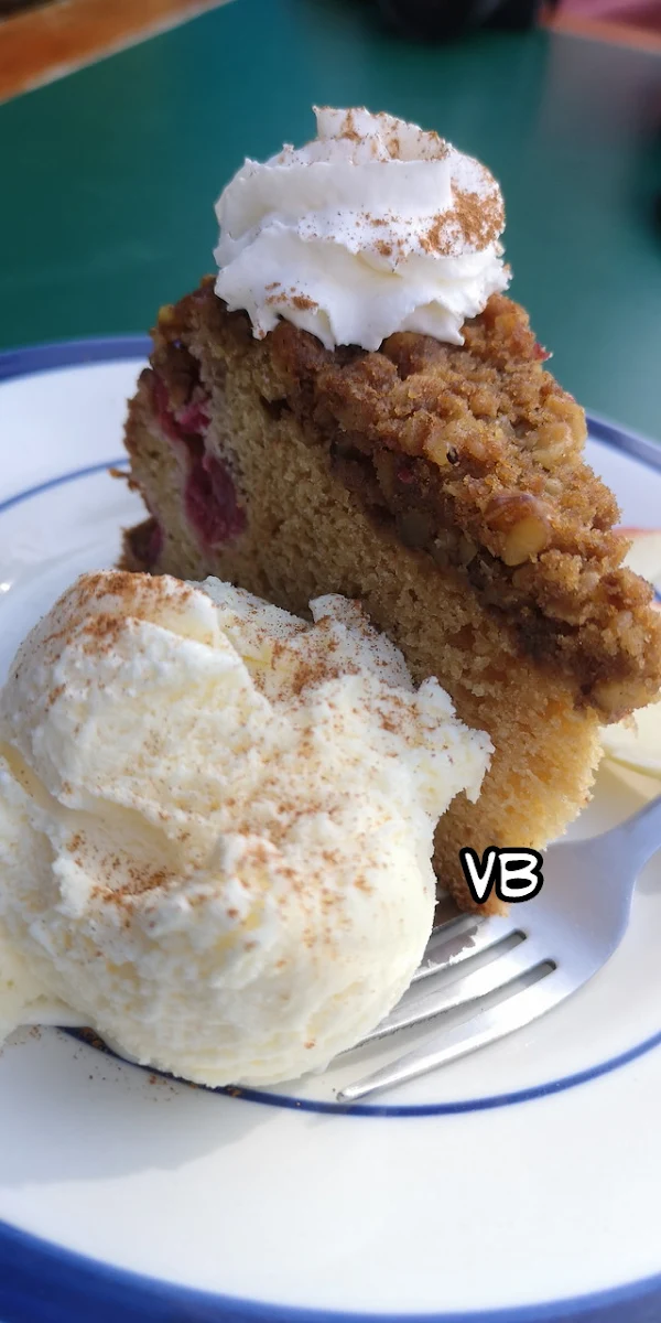 Cranberry Streusel Cake Served with Ice Cream Whipped Cream and Sliced Apples