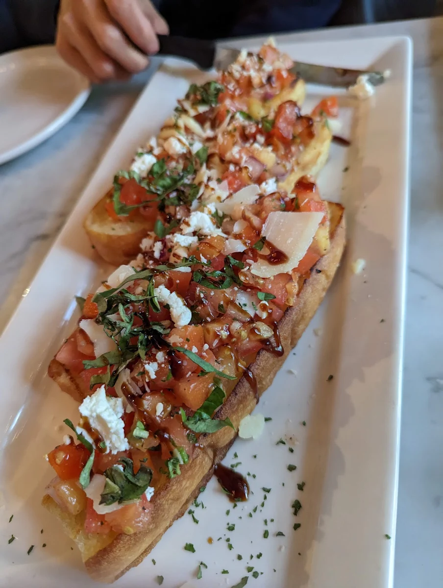 Bruschetta with Garlic Herbed Tomatoes Red Onions & Goat Cheese