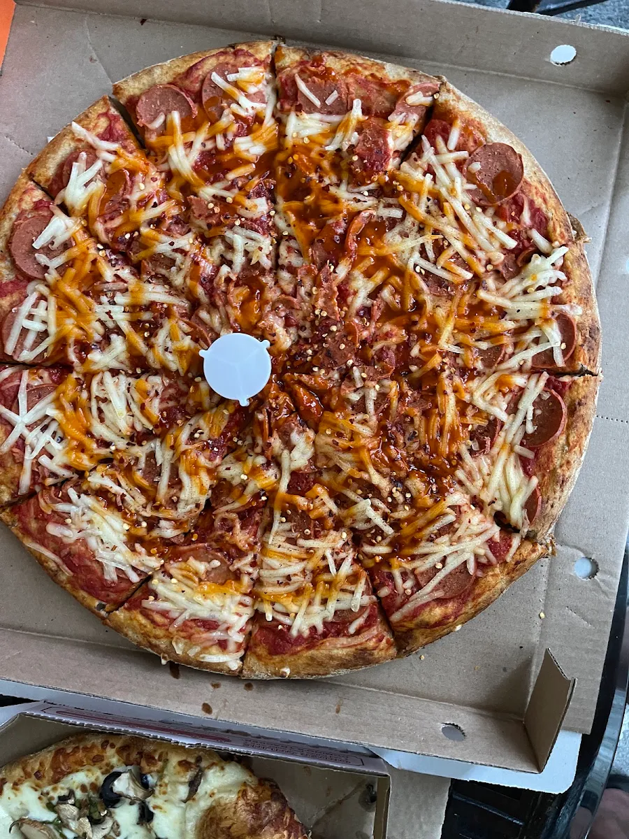 Vegan Cheeze Vegan Pepperoni Whole Wheat Thick Crust Pizza with a Drizzleof Hot Sauce