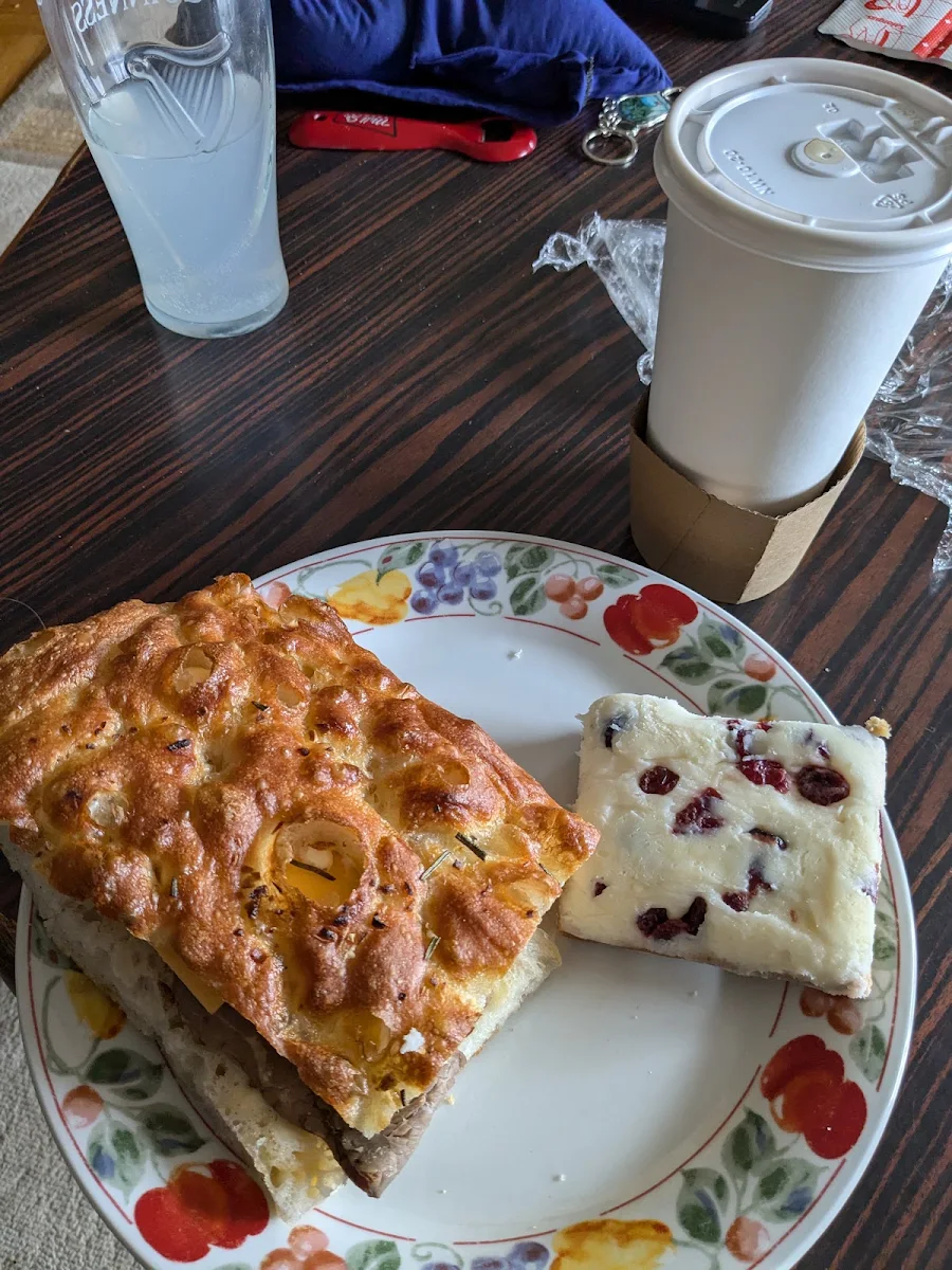 Roast Beef Cheddar Sriracha Mayo with Cranberry and White Chocolate Something and a Large Dark Roast