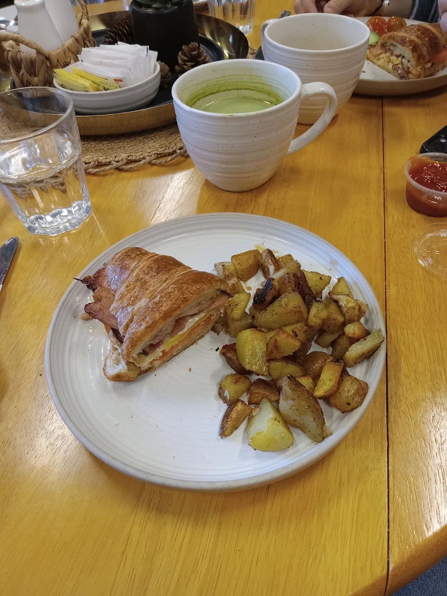 Croissant Breakfast Sandwich with Garlic Aoli Egg Bacon and Tomato