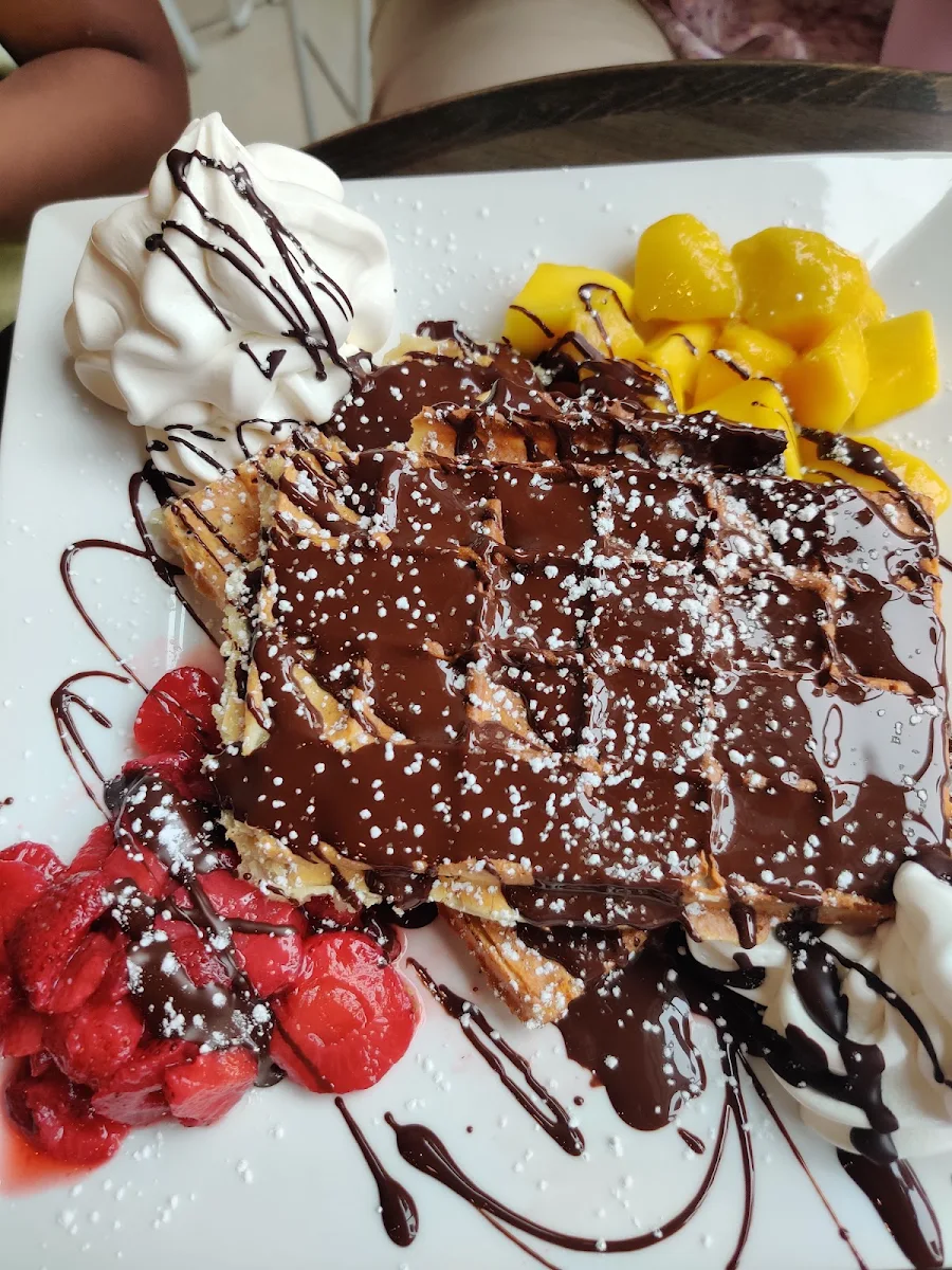 Waffle with Strawberries and Mango Served with Icecream and Dark Chocolate Topping