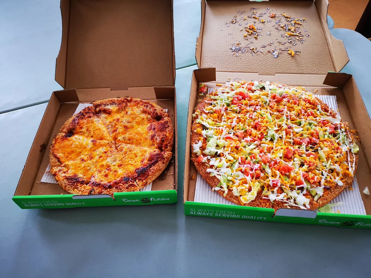 Large Nacho with Chicken Pizza and Smaller Pizza Is Just Cheese