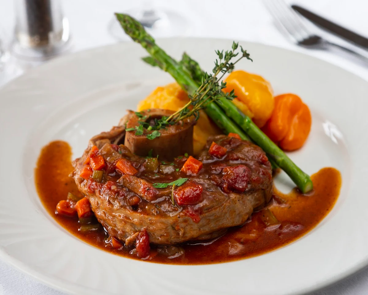 Osso Buco Braised in the Oven in a Milanese Sauce on a Bed of Parmesan Risotto