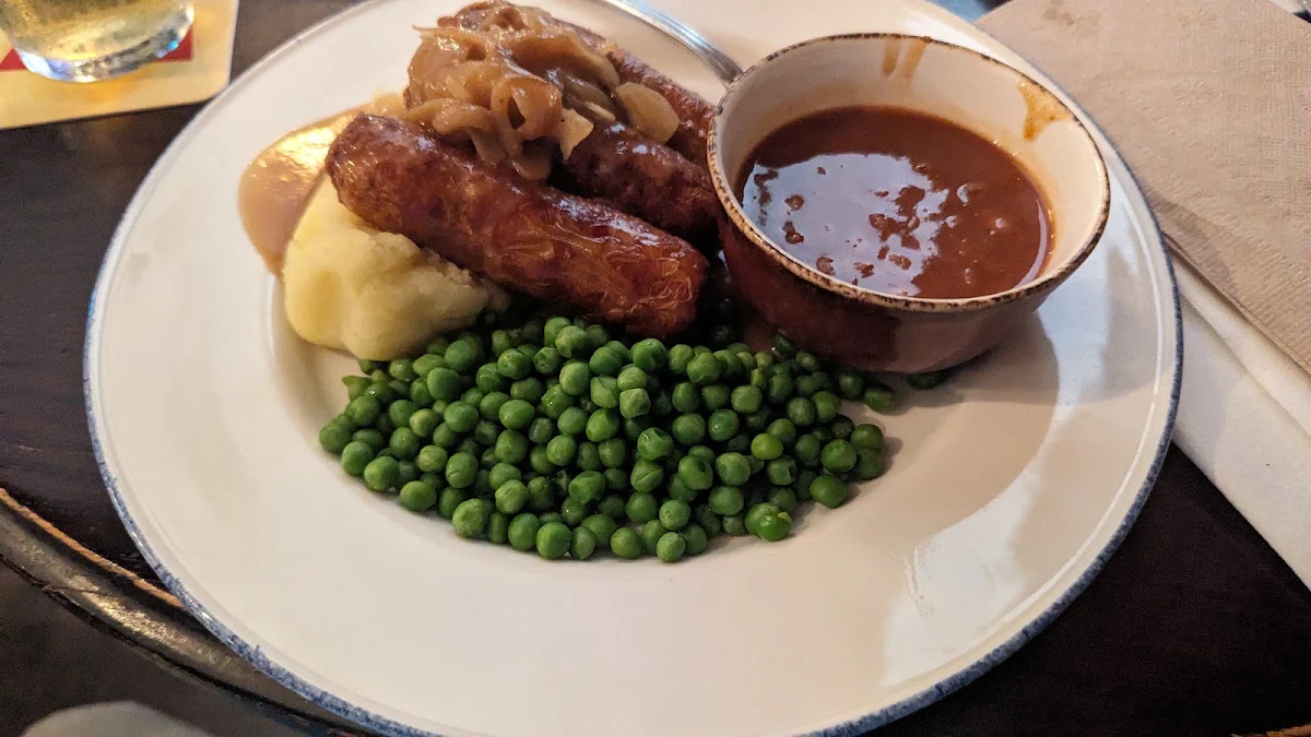 Bangers and Mash with Mashed Potatoes Baked Beans and Buttered Peas