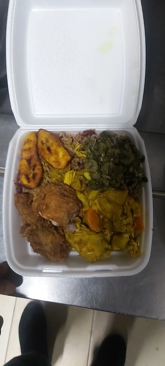 Rice and Peas Mix with Curry Chicken and Fry Chicken Along with Steam Callaloo and Fry Ripe Plantain