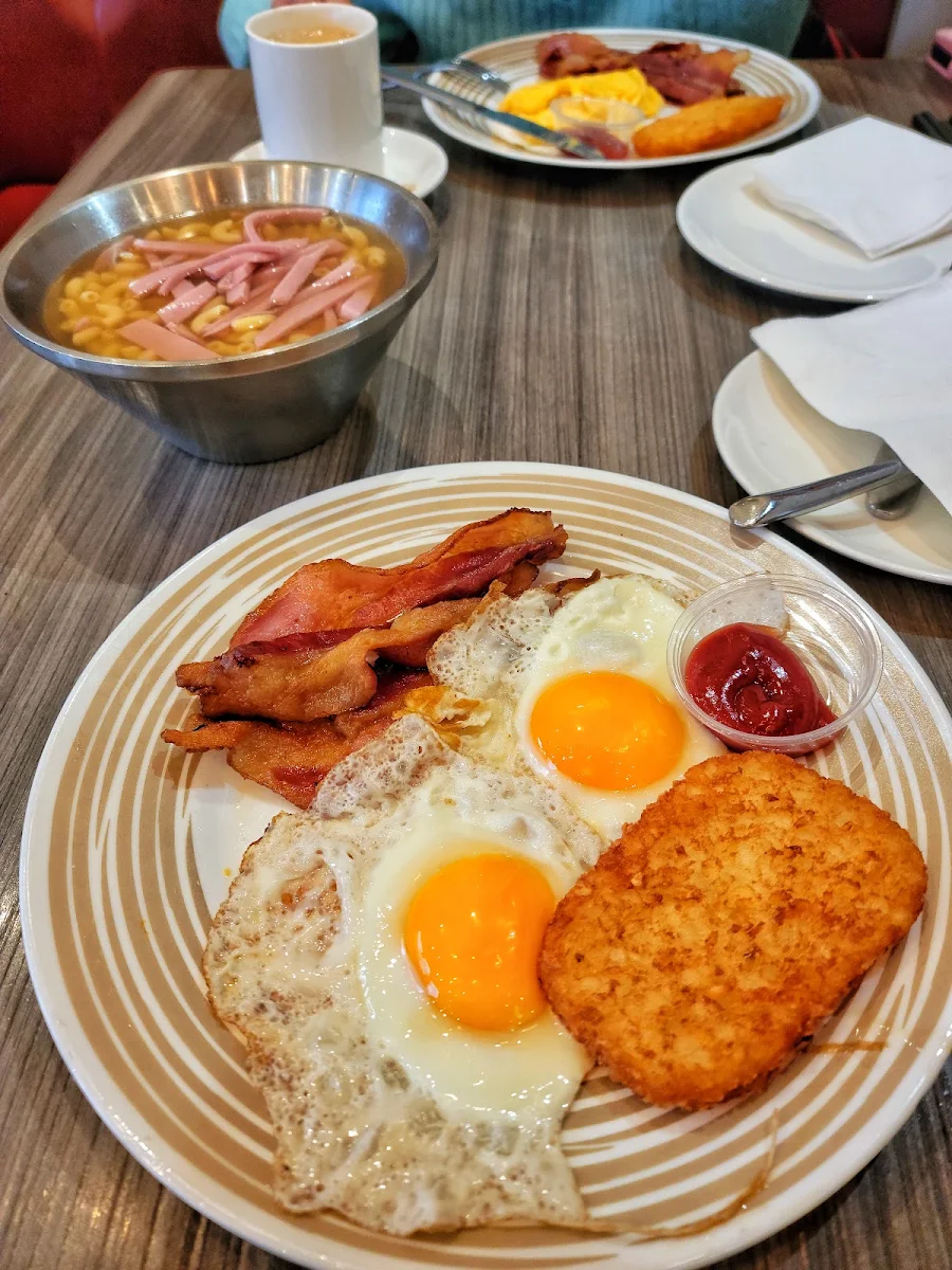 Pan Fried Steak Breakfast with Ham Eggs and French Toast