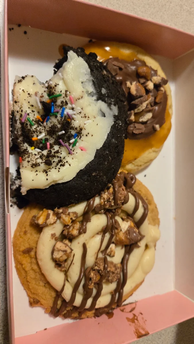 Birthday Cake Oreo Cookie on Top of Peanut Butter Snickers Cookie and Caramel Shortbread with Twix