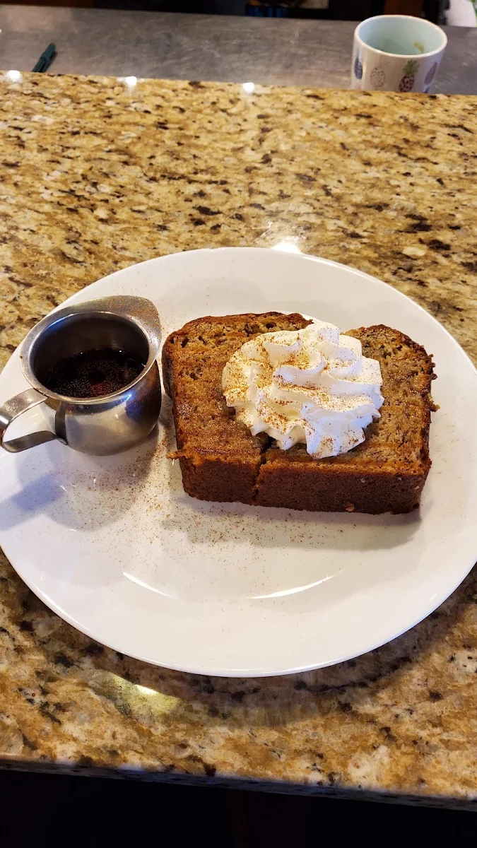 Banana Bread with Grass Fed Butter Topped with Maple Syrup and Whip Cream