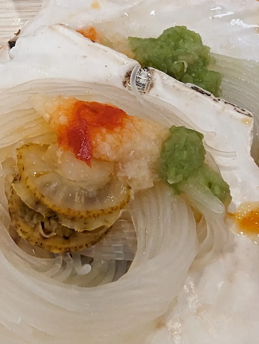 Clam on Glass Noodles with a Bit of Wasabi Served on a Scallop Shell