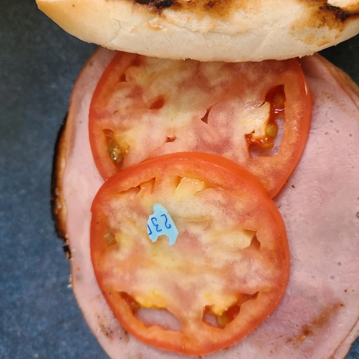 A Toasted Ham Tomato with Mayo Bagel