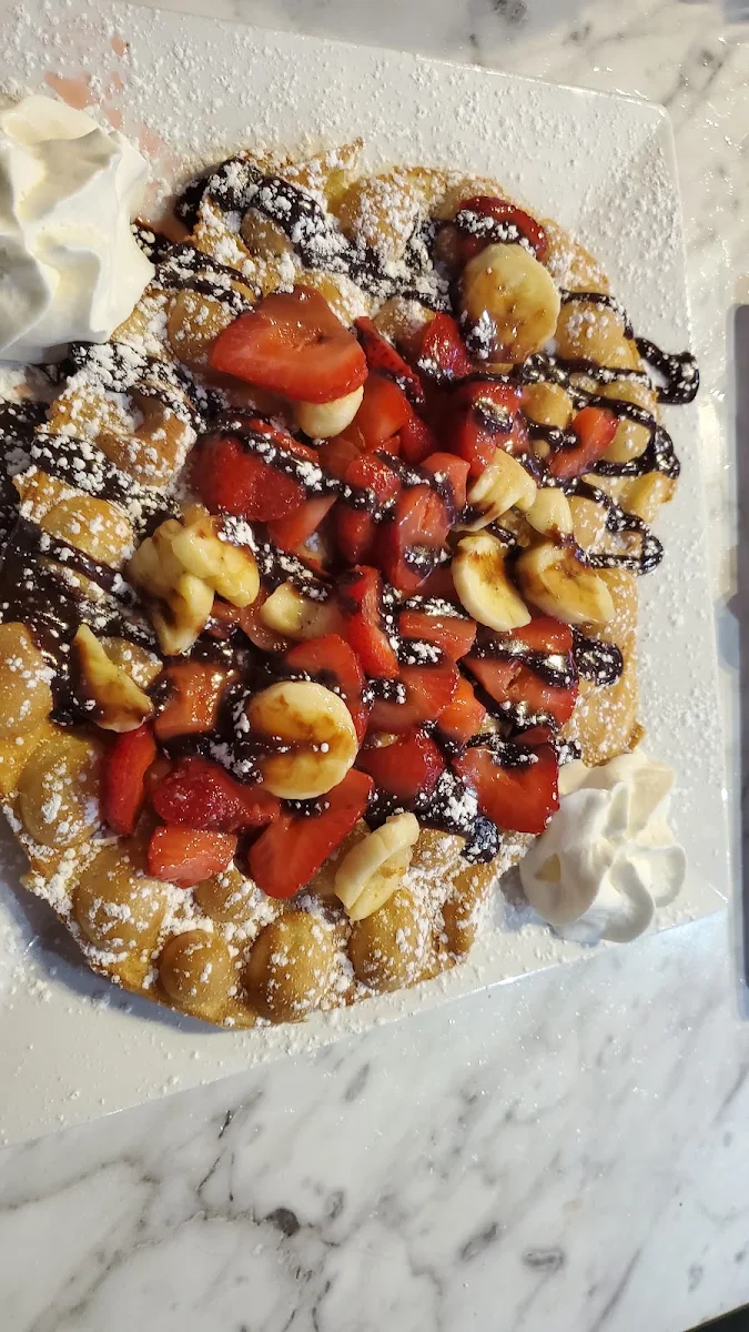 Fresh Bubble Waffle Topped with Cheesecake Warm Brownies Nutella and Strawberries