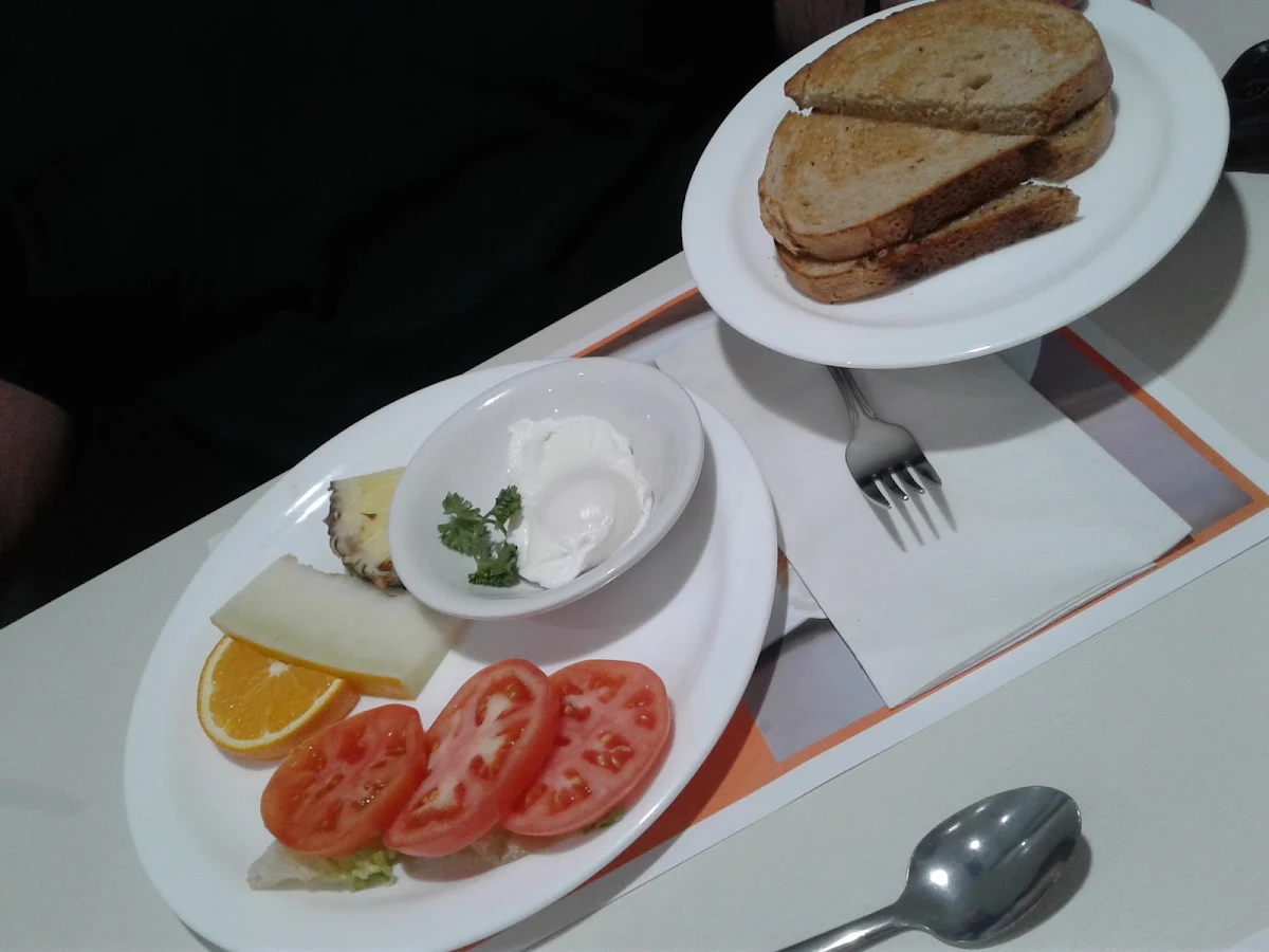 Poached Egg with Side of Fruit and Tomato Rye Toast