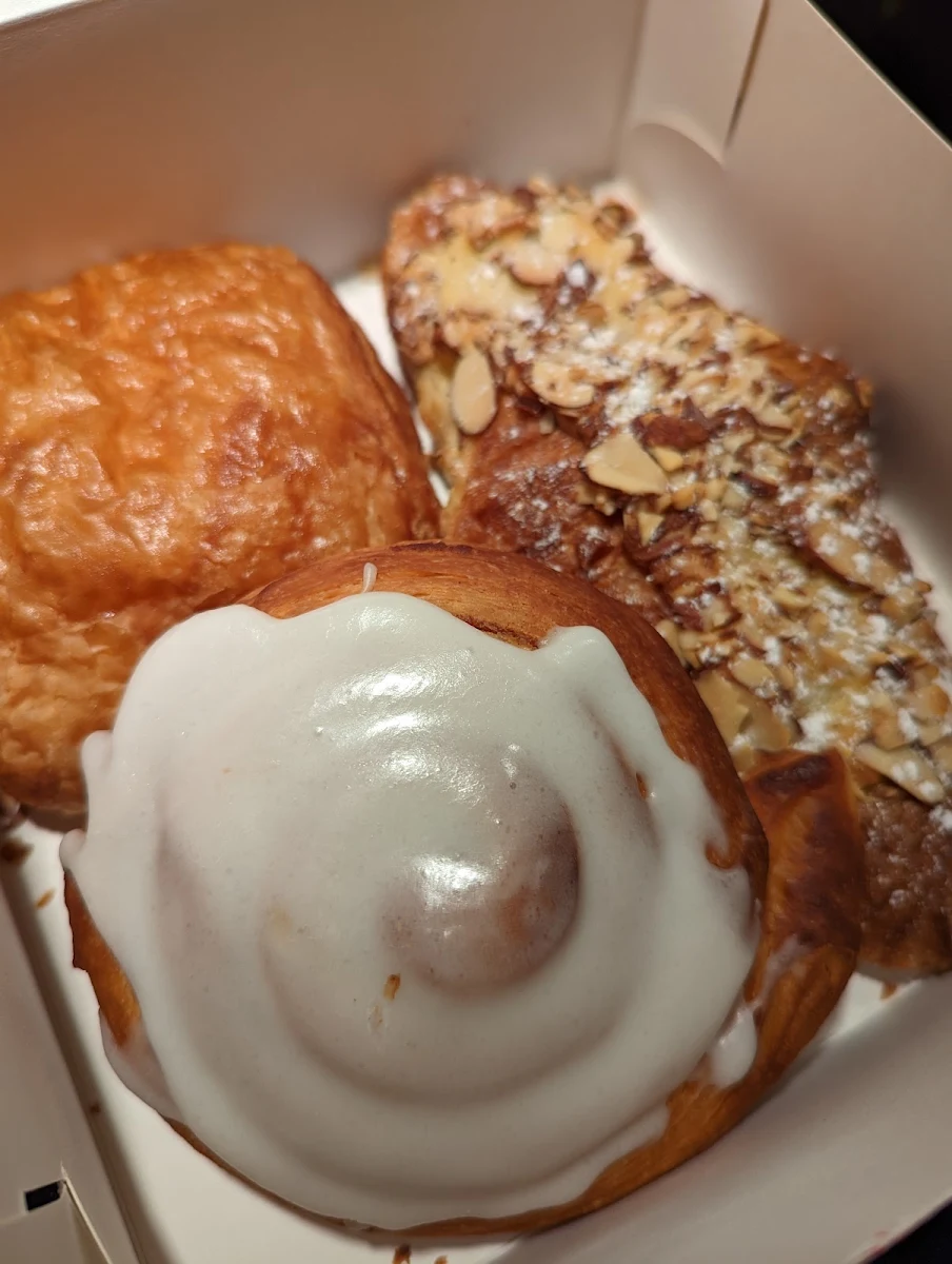 Chocolatine Almond Croissant and Cinnamon Roll on the Bottom