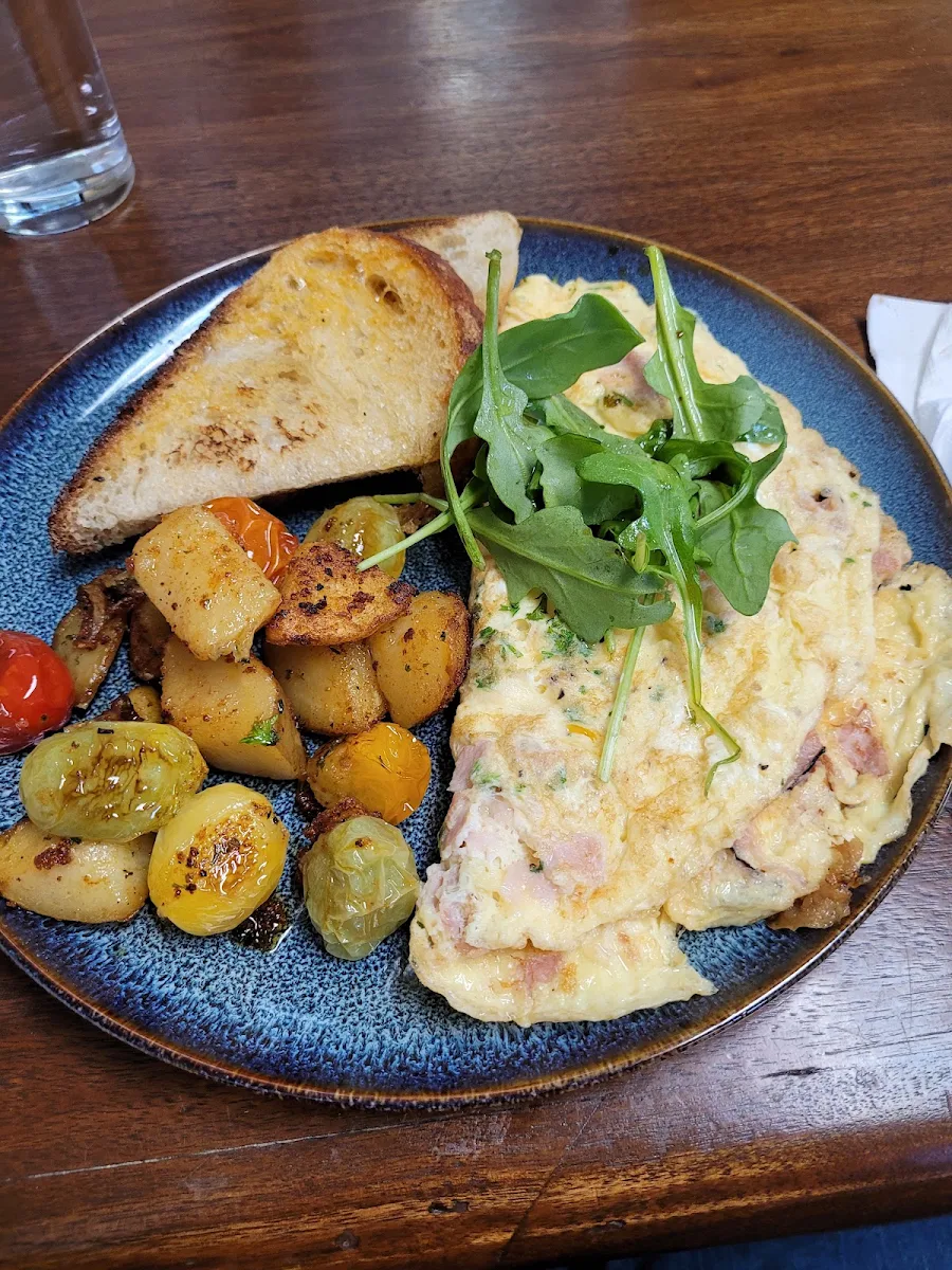 Omelette with Potatoes Tomatoes and Sourdough Toast