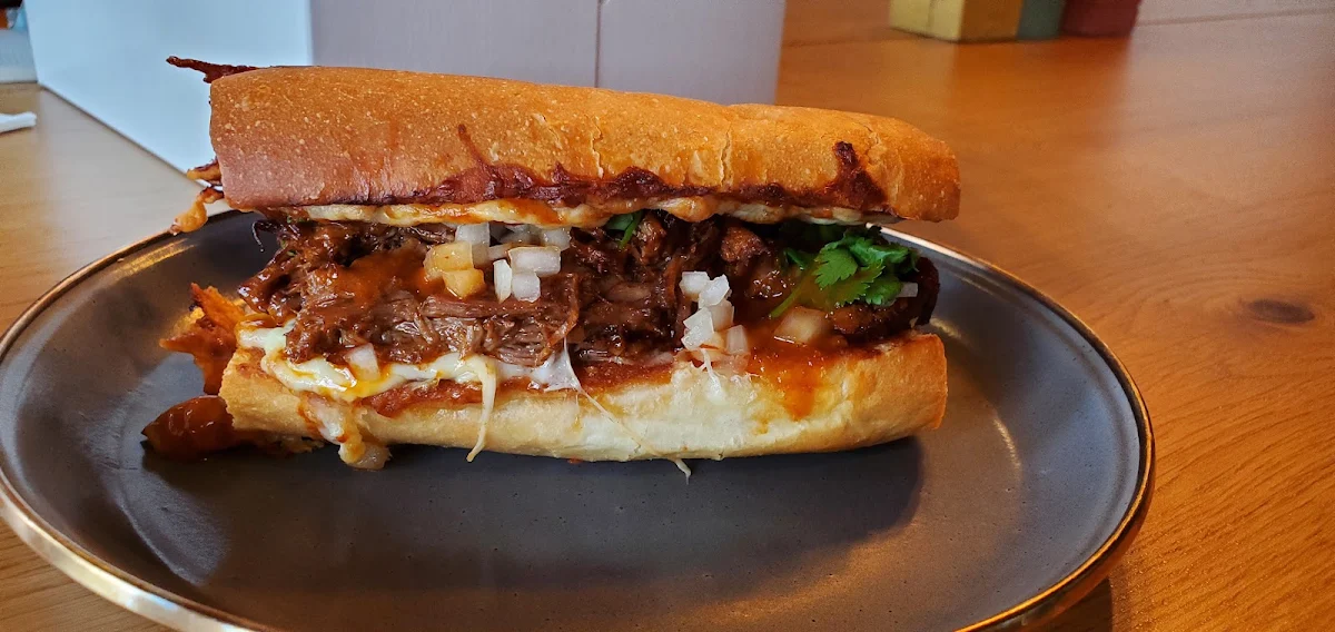 Berria Braised Chuck Roast Fresh Onion Melty Mozza Cheese Fresh Cilantro Crusty French Roll