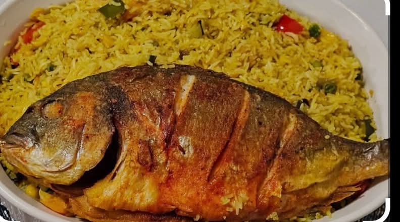 Fried rice with full fried tilapia fish