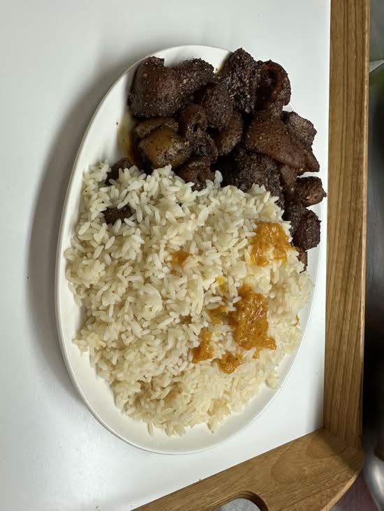 Spicy cow skin with fried or jollof rice