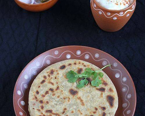 Mix paratha with dahi and achar