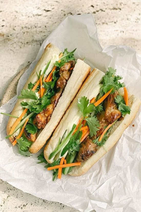 Baguette with stewed chicken , cilantro, onions, cucumbers and pickled vegetables