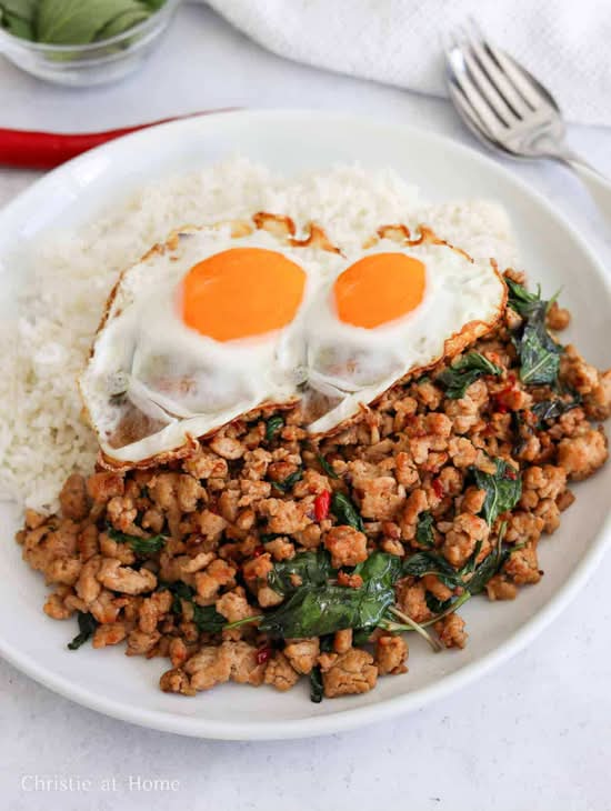 Pad Kra Pao (Pad Krapow)  (mild/ medium or hot) (2 eggs, stir-fried ground pork, white onions, basil, and green beans served with rice)