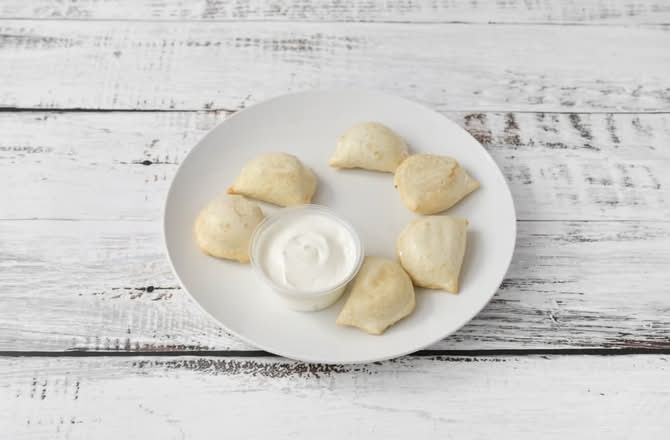 Junior's Perogies with side of sour cream
