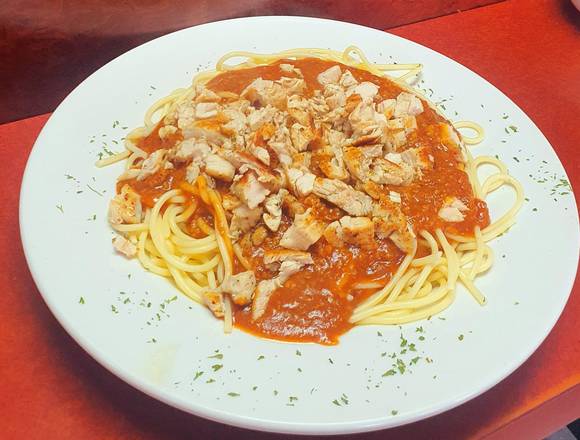 Spaghetti with homemade meat sauce topped with fresh grilled chicken breast.