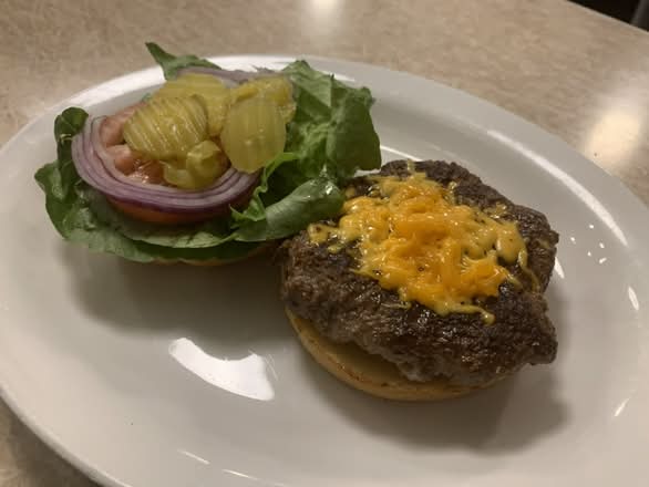 Cheeseburger ( our signature 6oz burger with cheddar cheese made in house with lean ground beef)