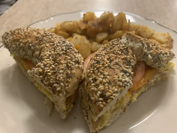 Breakfast Bagel with 1 large egg, bacon, cheese, tomato, and homefries