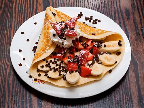 Kids: hazelnut chocolate chip crepe topped with strawberries and bananas